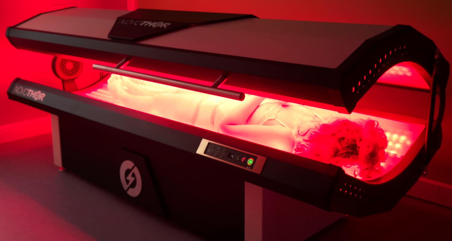 NovoTHOR full-body near-infrared light therapy bed glowing red during a session at Innovation Wellness in Early, Texas